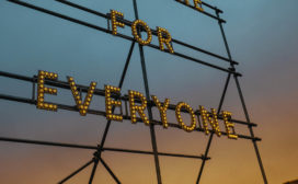 At dusk an electric sign reads "For Everyone"