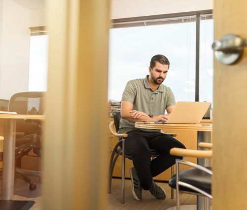 Man working on a laptop in an office