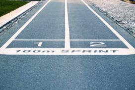 A running track with the word sprint painted on it.