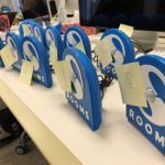 Twelve SPR Rooms sensors housed in blue 3D printed casings sitting on a table
