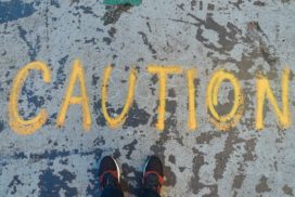 In yellow the word "caution" is written on the pavement