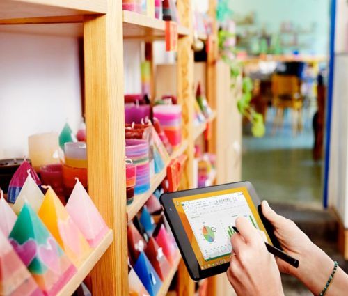 shop keeper analyzing data about candle inventory