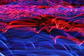 Curves of red and blue light flow from left to right