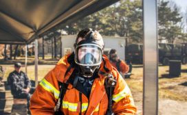 A firefighter wearing a gas mask.