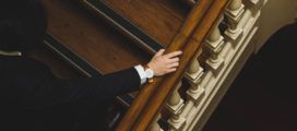 A man in a suit is climbing the stairs.