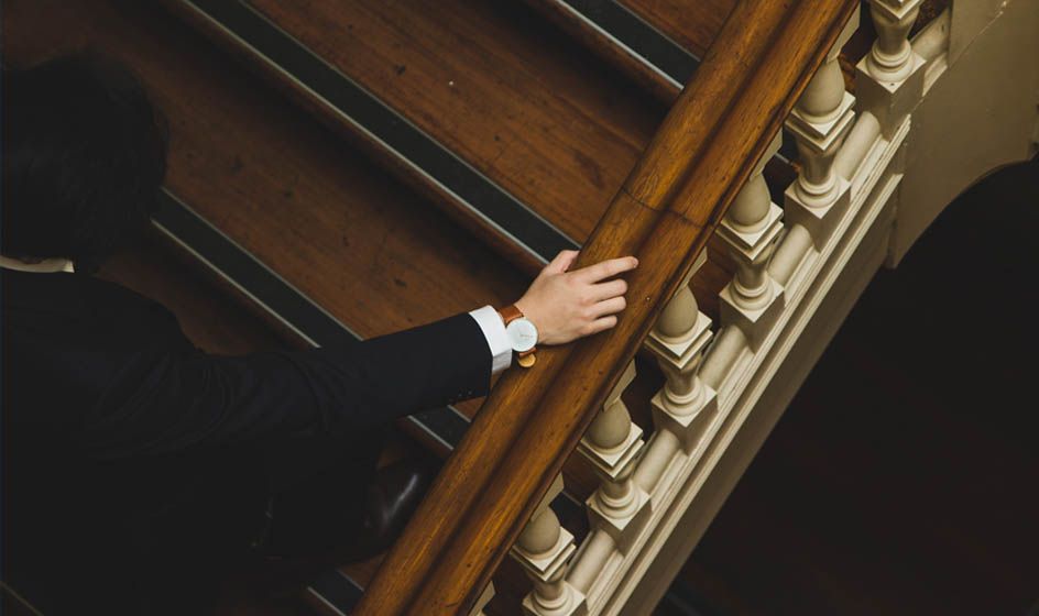 A man in a suit is climbing the stairs.