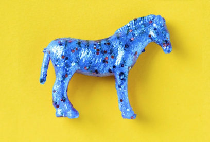A toy zebra covered in blue glitter