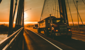 A truck driving on a bridge.