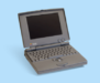 Macintosh PowerBook, featuring a built-in trackball, internal floppy drive, and palm rests