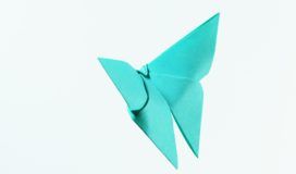 A blue origami butterfly on a white background.