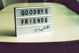 A sign that says goodbye friends on a table.