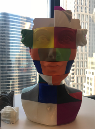 A 3d printed bust of a woman sitting on a desk, representing the empowerment of women in technology.