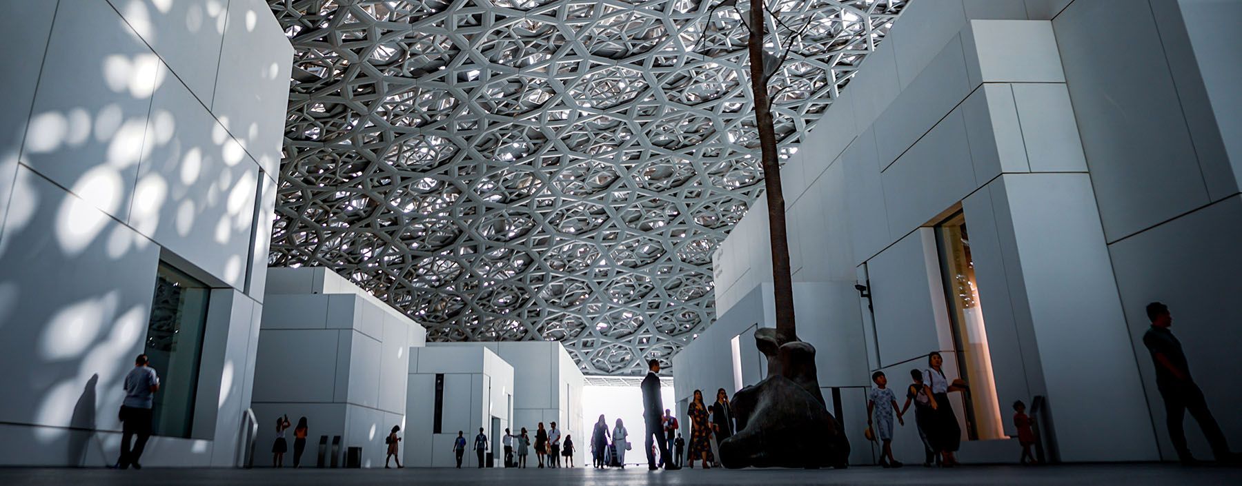 The ceiling of a museum has a lot of mirrors on it.