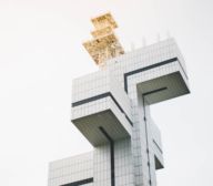 A white building with a clock on top of it.