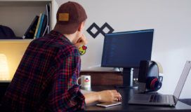 A man sitting at a desk working on a Databricks computer.