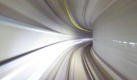 A blurry image of a train traveling through a tunnel.
