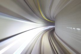 A blurry image of a train traveling through a tunnel.