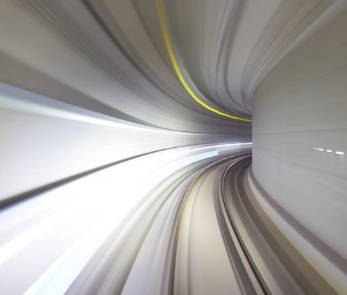 A blurry image of a train traveling through a tunnel.