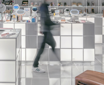 A person walking through a store with a lot of white cubes.