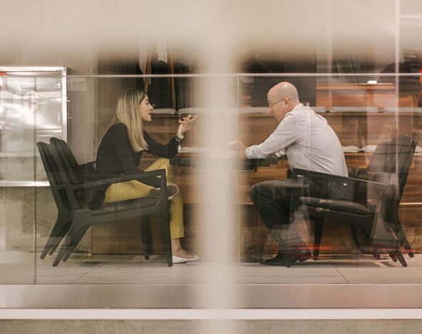 A man and woman sitting at a table in a restaurant.