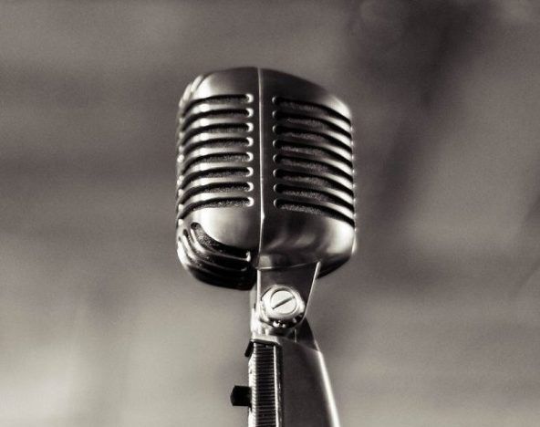 A black and white photograph of a microphone.