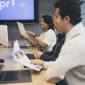 People in a conference room discuss documents