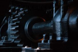 A close up of a gear in a dark room.