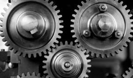 Black and white image of gears on a machine.
