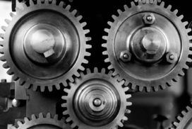 Black and white image of gears on a machine.