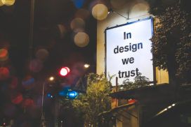 A sign that says in design we trust.