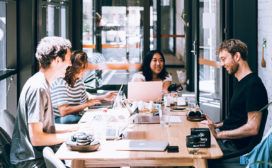 A group of people sitting around a table discussing a data platform.