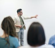 A man is giving a presentation on a data platform to a group of people.