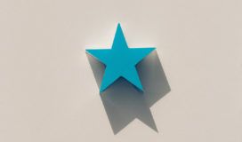 A blue star on a white wall.