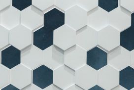 A detailed view of a white and blue tiled wall.