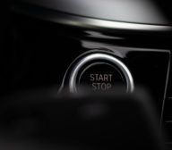 A close up of the start button on a car.