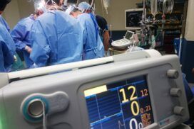 A group of people in a hospital operating room.