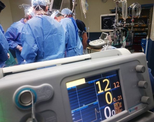 A group of people in a hospital operating room.