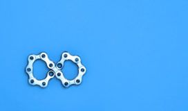 A pair of gears on a blue background.