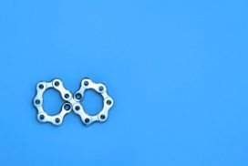 A pair of gears on a blue background.