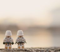 Two LEGO stormtroopers strategically positioned next to a tranquil body of water, demonstrating captivating UX design.