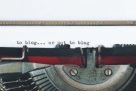 An antique typewriter on display with the words "to blog or not to blog" prominently displayed.
