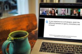 A laptop on a table next to a coffee mug, showcasing its sleek UX design.