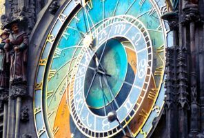 Close up of a colorful, ornate clock in a clock tower.