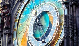 Close up of a colorful, ornate clock in a clock tower.