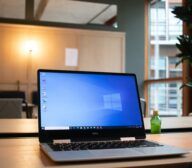 A laptop on a wooden table.