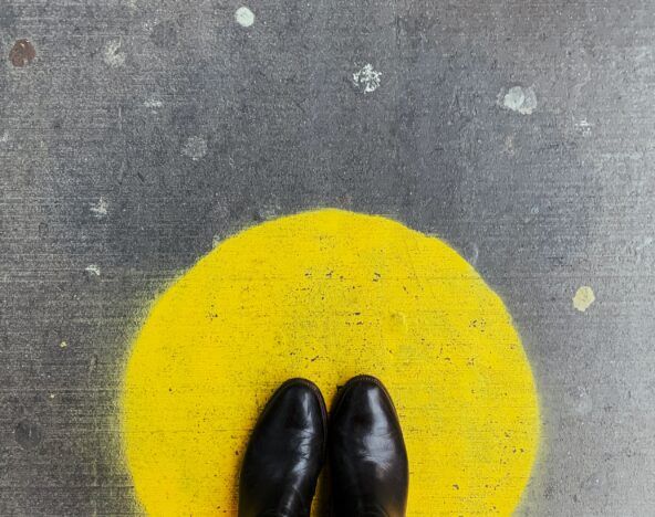 Person standing on a yellow dot.
