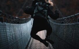 Woman jumping on a rope bridge