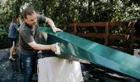 Two men building a kayak