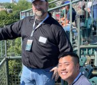 Two man at a Cubs roof top event