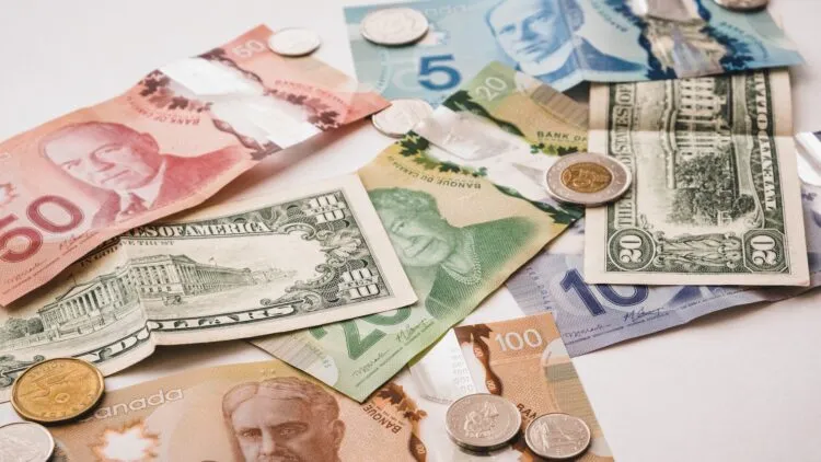 International currency lying on a white table.